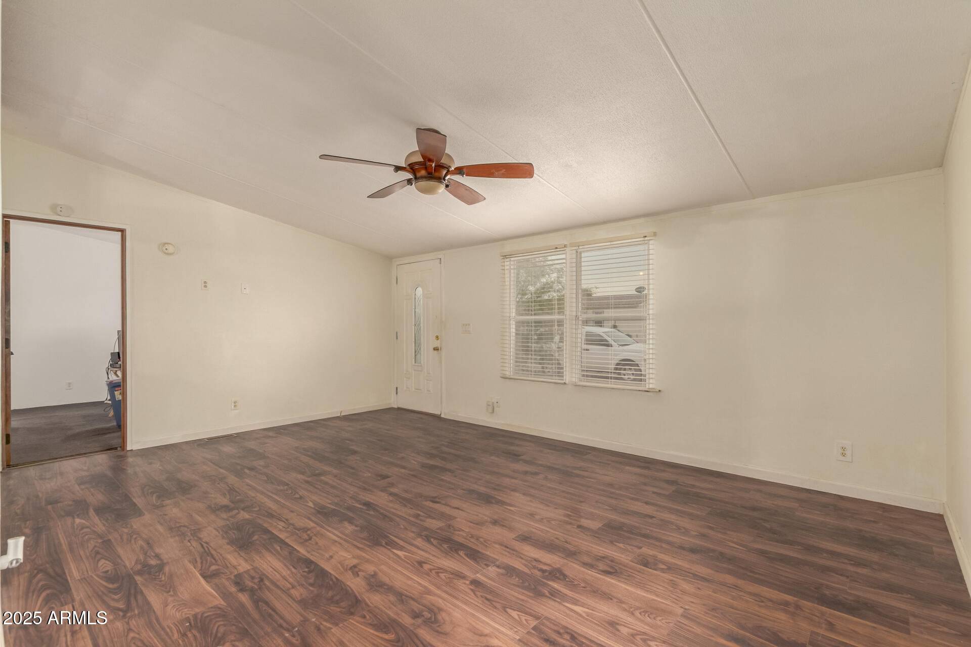 11404 West Custer Road Arizona City, AZ 85123 - Photo 3 of 27 wooden floor in an empty room with a window