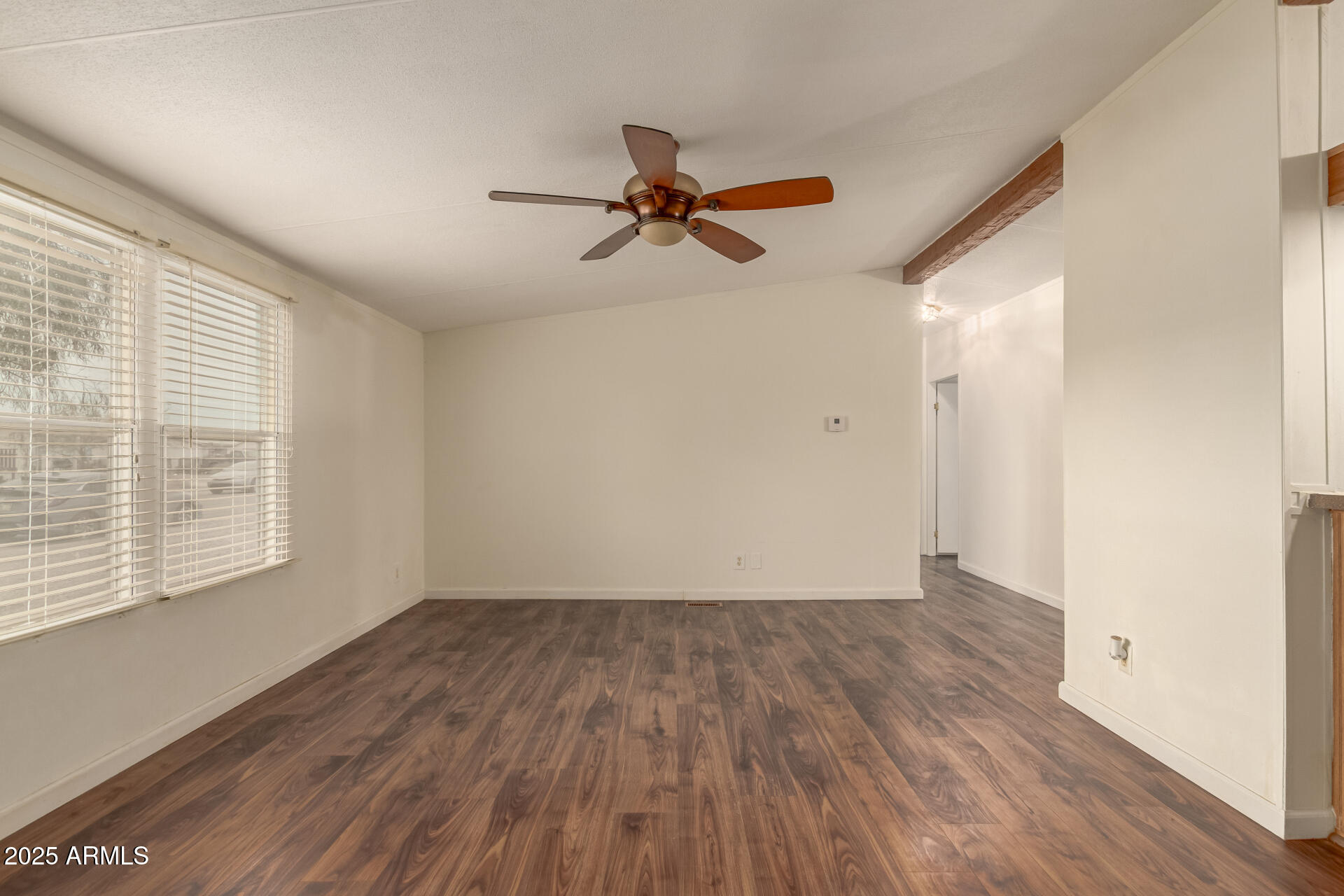 11404 West Custer Road Arizona City, AZ 85123 - Photo 4 of 27 an empty room with wooden floor fan and windows