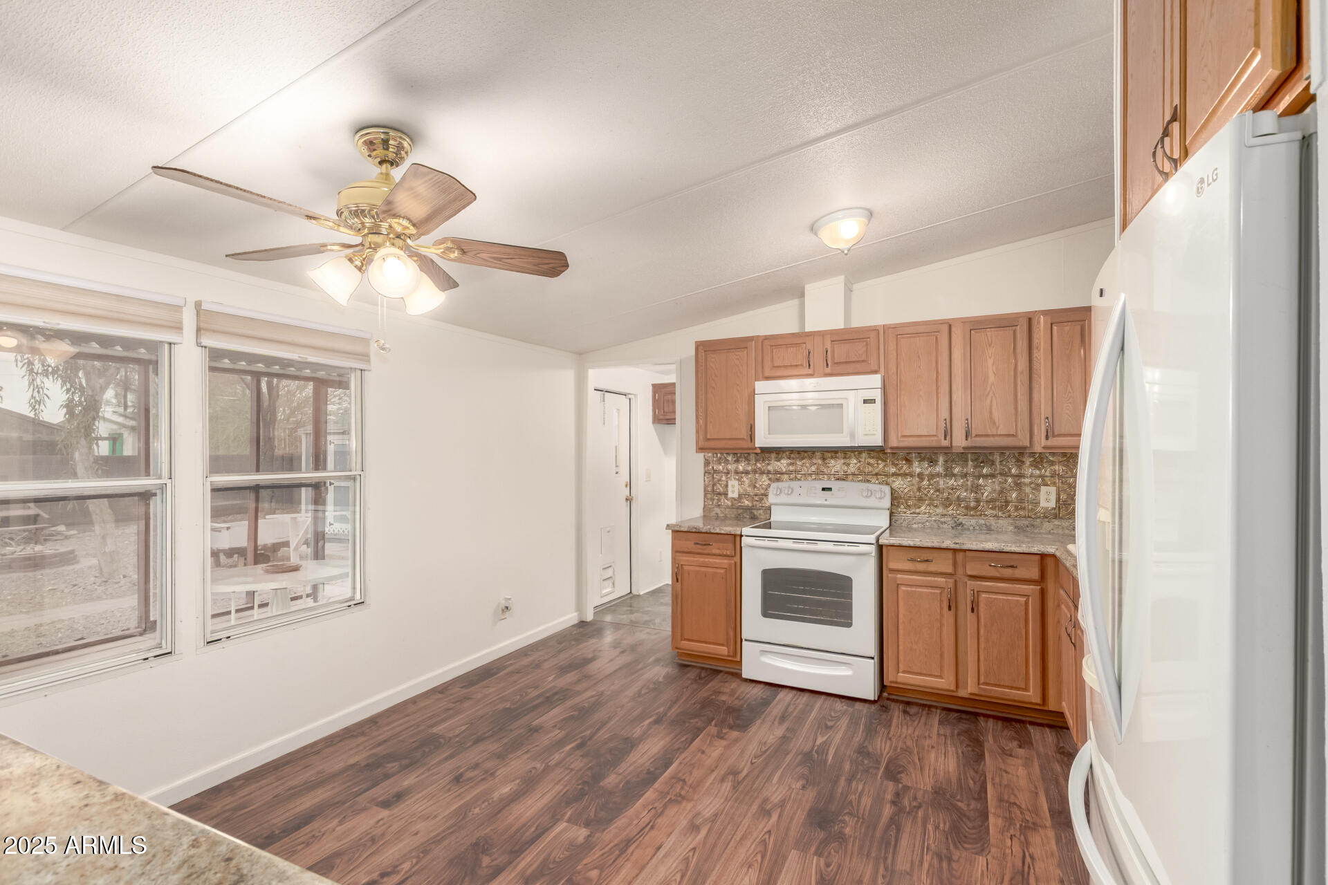 11404 West Custer Road Arizona City, AZ 85123 - Photo 6 of 27 a kitchen with stainless steel appliances granite countertop a stove and a white cabinets