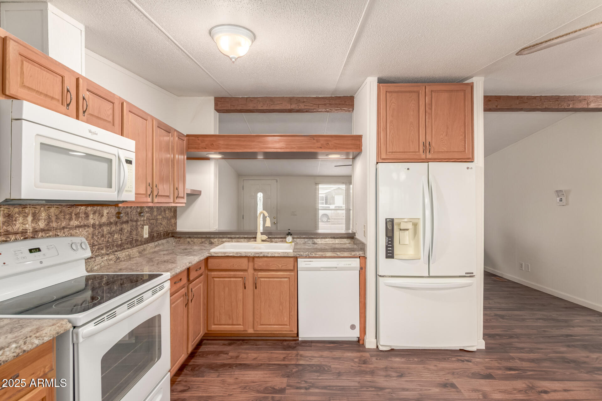 11404 West Custer Road Arizona City, AZ 85123 - Photo 7 of 27 a kitchen with a sink stove and cabinets