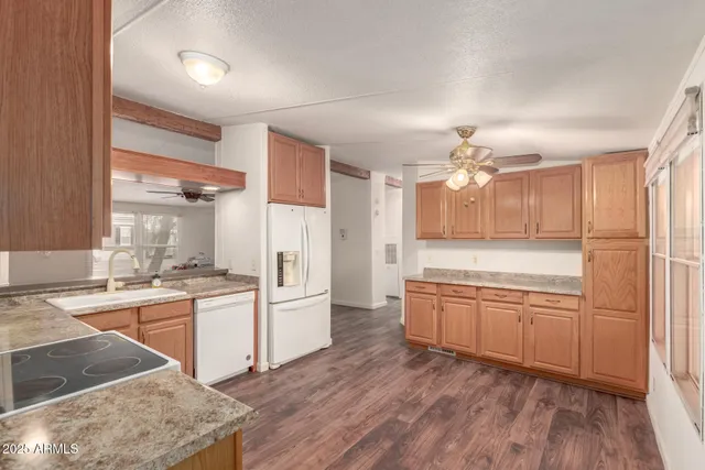 a large kitchen with cabinets wooden floor and stainless steel appliances