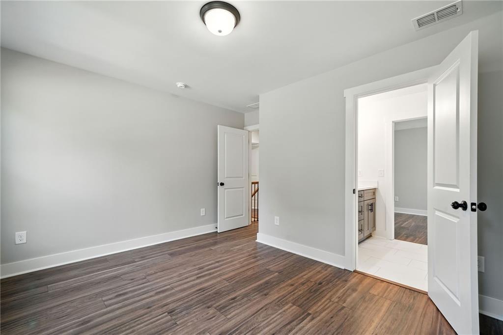 125 Old Alabama Road Southeast Emerson, GA 30137 - Photo 28 of 37 an empty room with wooden floor and mirror