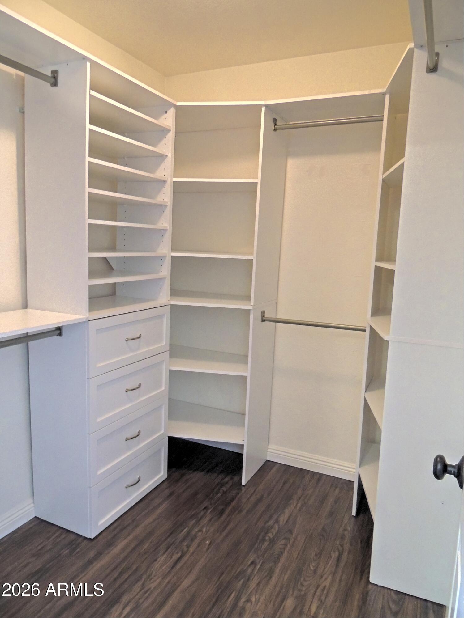 4409 East Dry Creek Road Phoenix, AZ 85044 - Photo 20 of 34 a view of walk in closet with empty racks