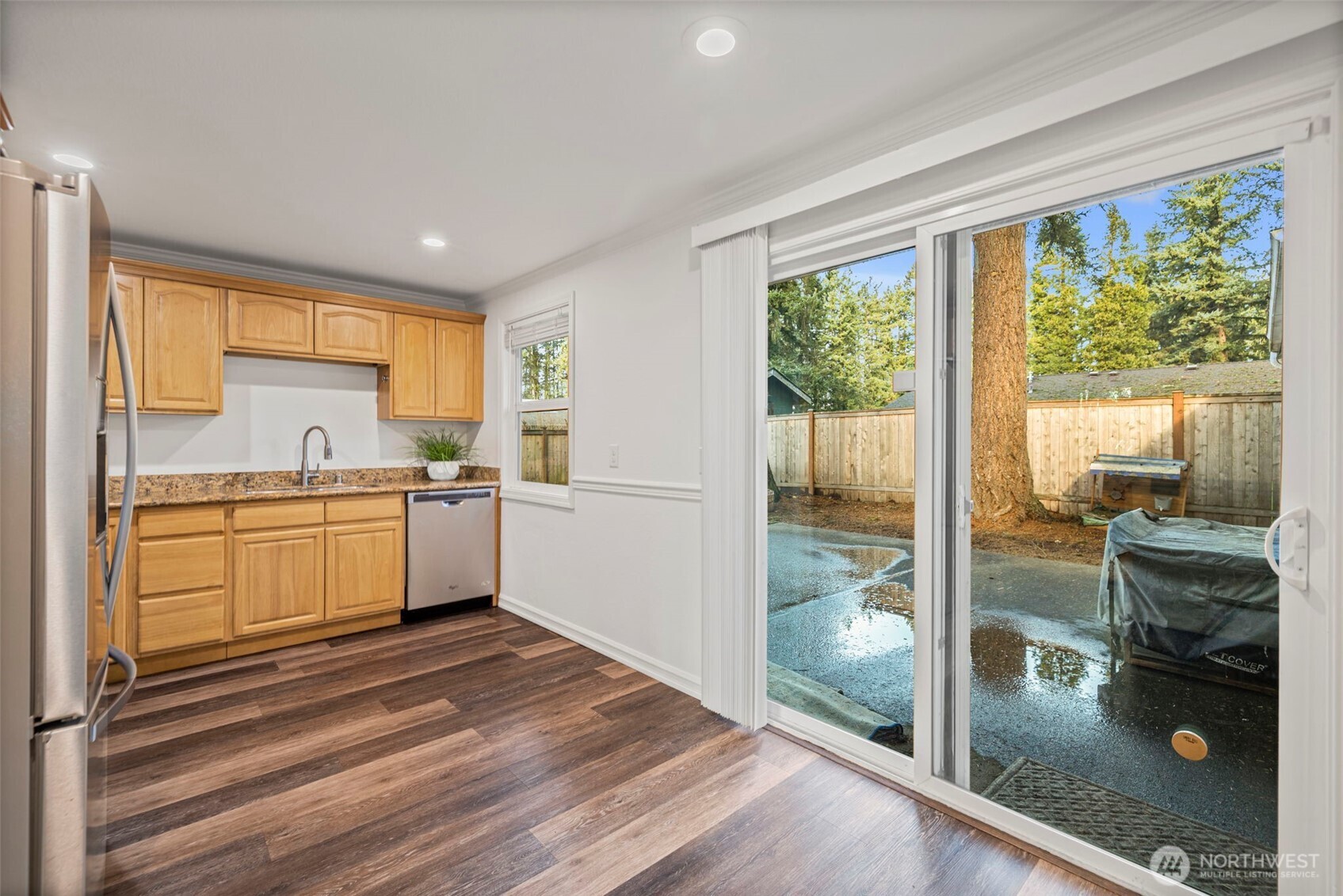 19006 Southeast 269th Street Covington, WA 98042 - Photo 12 of 32 a kitchen with a refrigerator a stove top oven and a large window