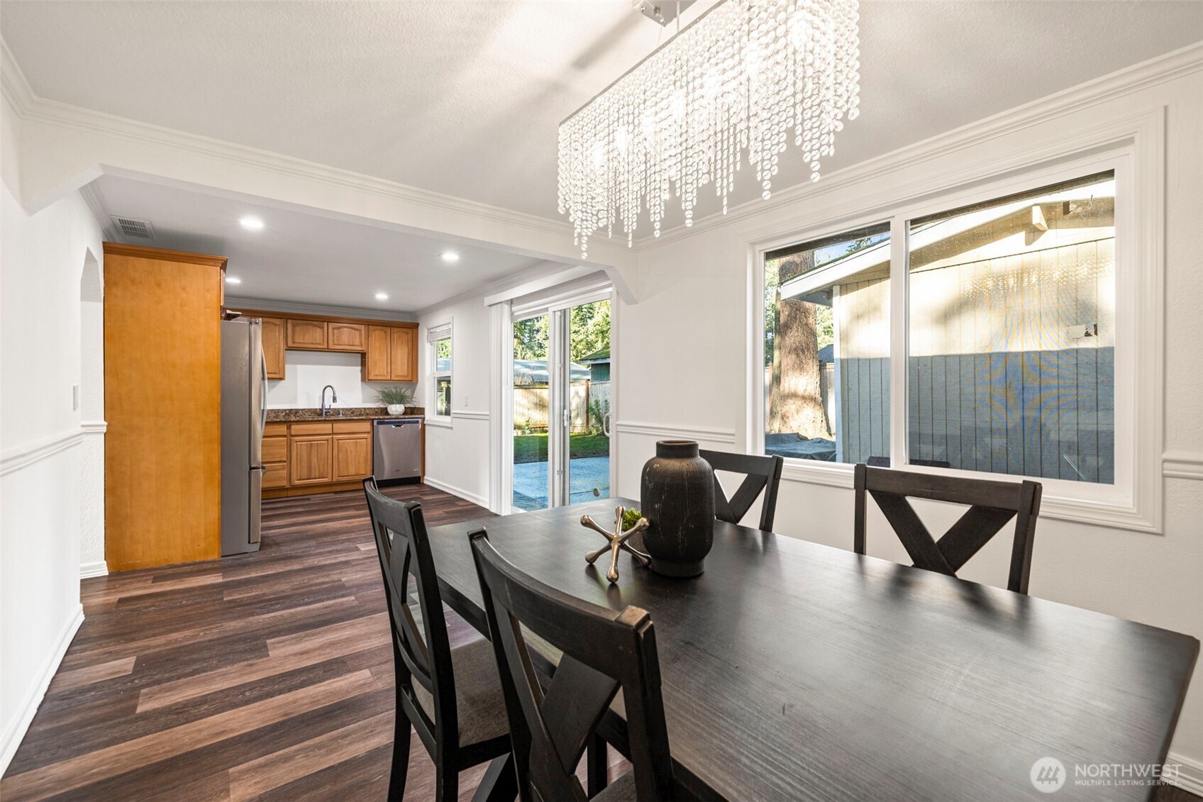 19006 Southeast 269th Street Covington, WA 98042 - Photo 15 of 32 a dining room with furniture a chandelier and wooden floor
