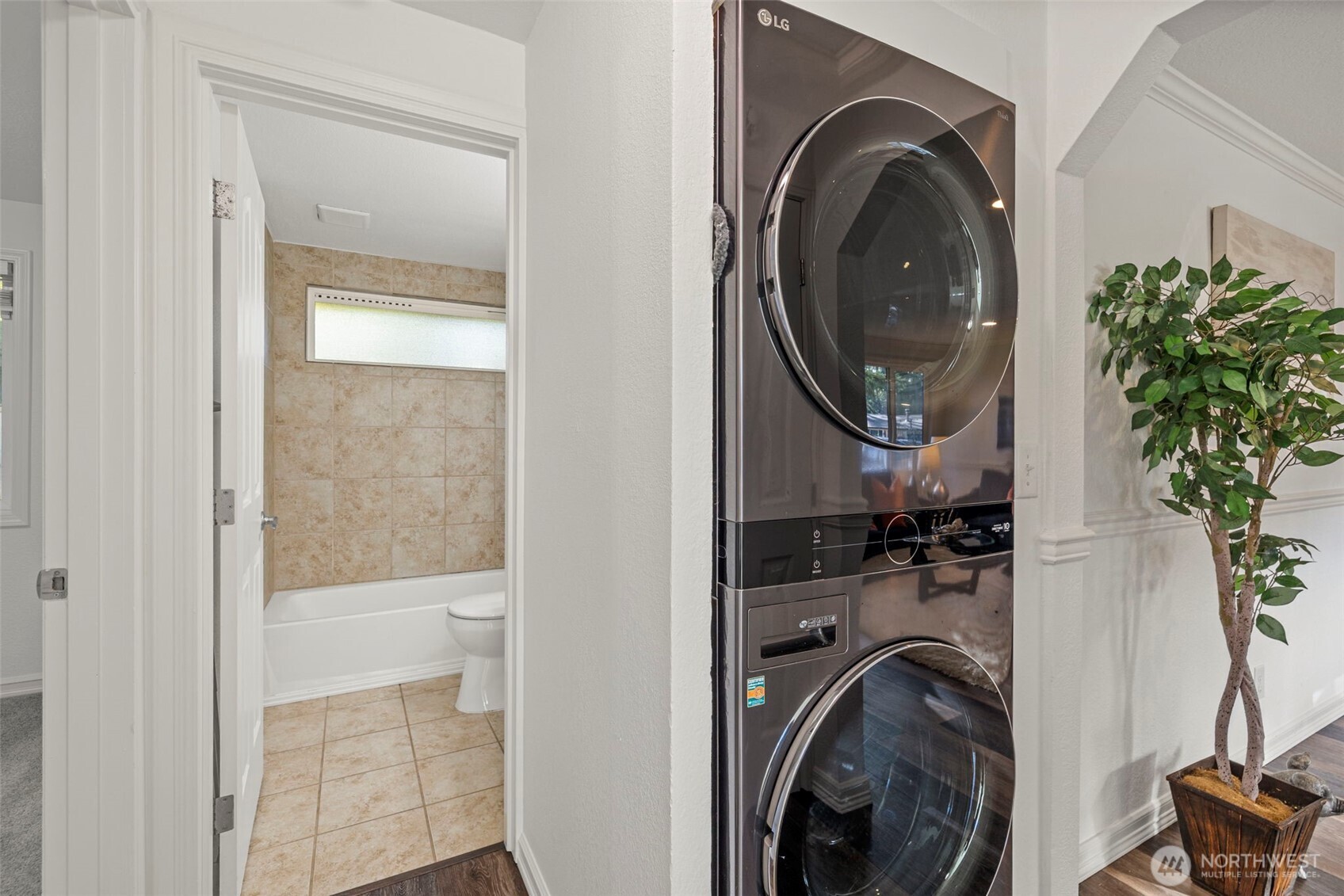 19006 Southeast 269th Street Covington, WA 98042 - Photo 18 of 32 a view of a bedroom with washer and dryer