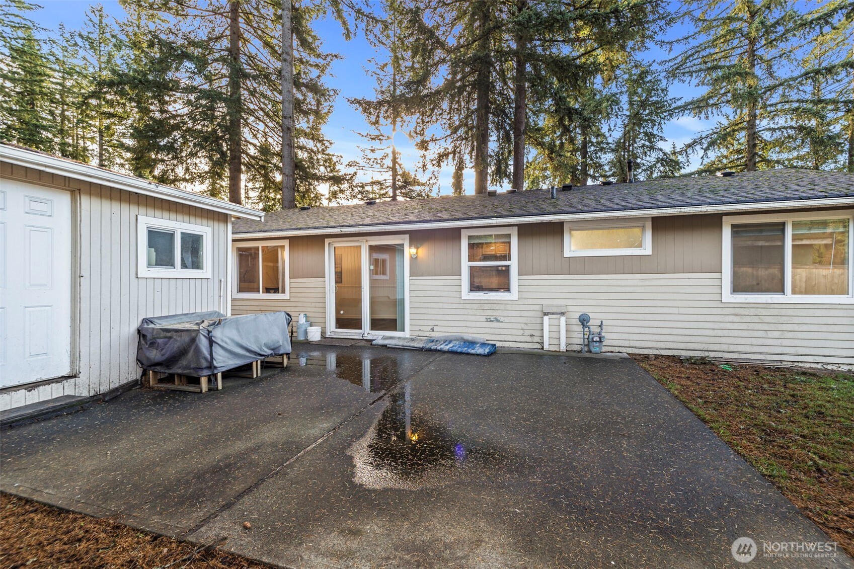 19006 Southeast 269th Street Covington, WA 98042 - Photo 23 of 32 a backyard of a house with table and chairs