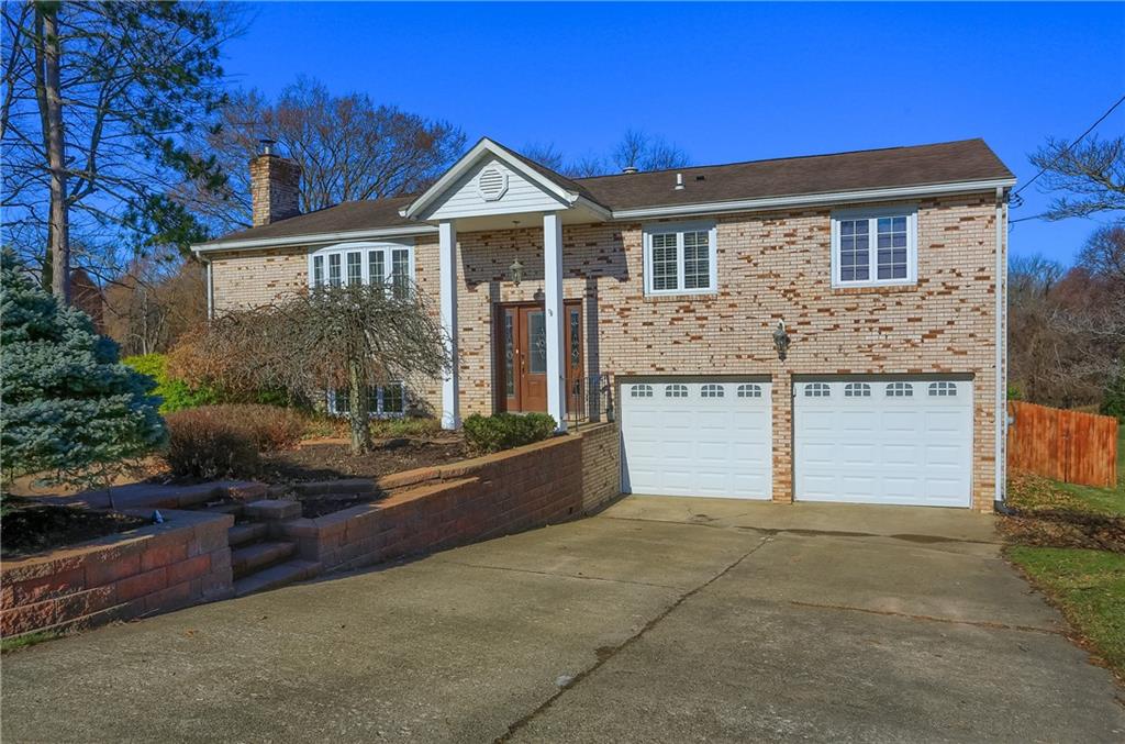 265 Shafer Road Moon Township, PA 15108 - Photo 1 of 50 a front view of a house with a yard and garage