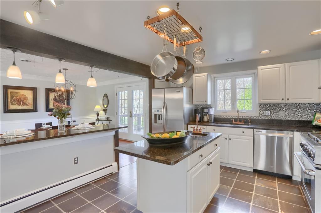 265 Shafer Road Moon Township, PA 15108 - Photo 14 of 50 a kitchen with a sink dishwasher and white cabinets with wooden floor