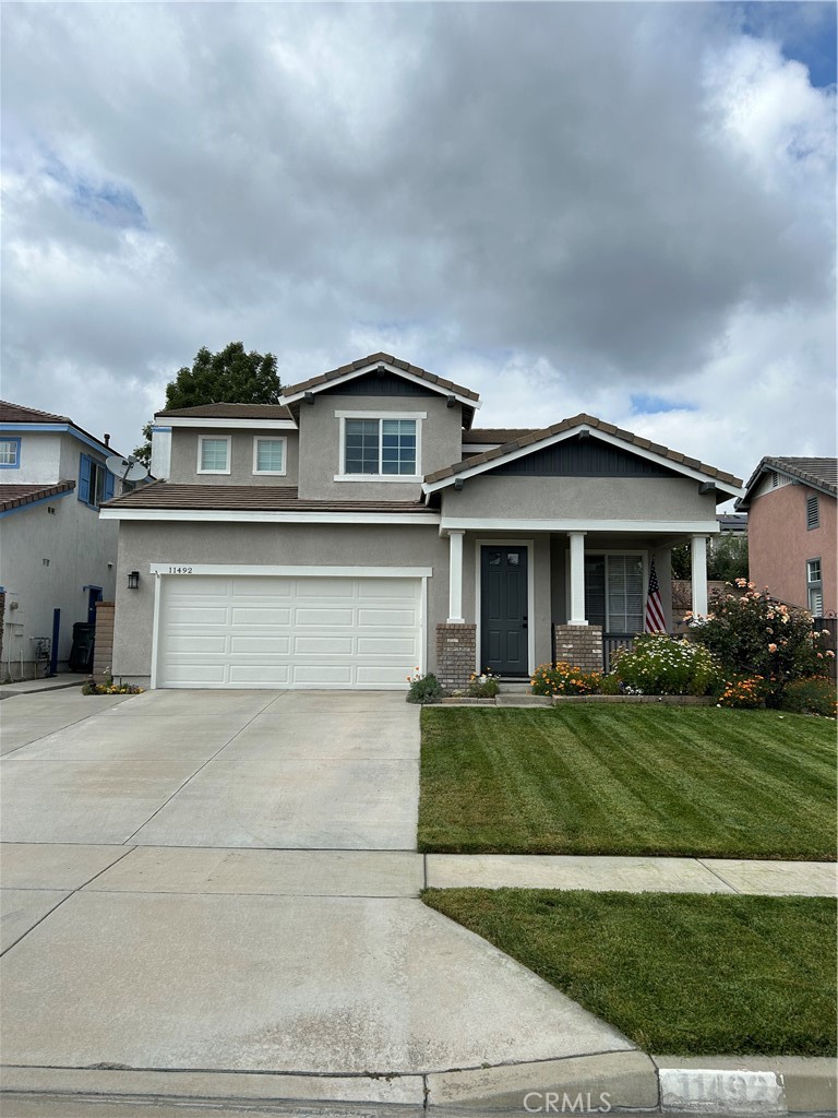 11492 Fallingstar Court Rancho Cucamonga, CA 91701 - Photo 1 of 22 a front view of a house with a garden