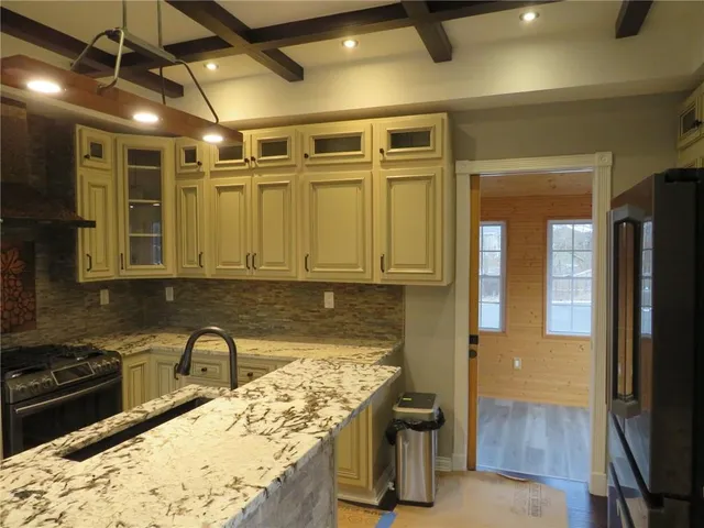 a kitchen with a refrigerator and a sink