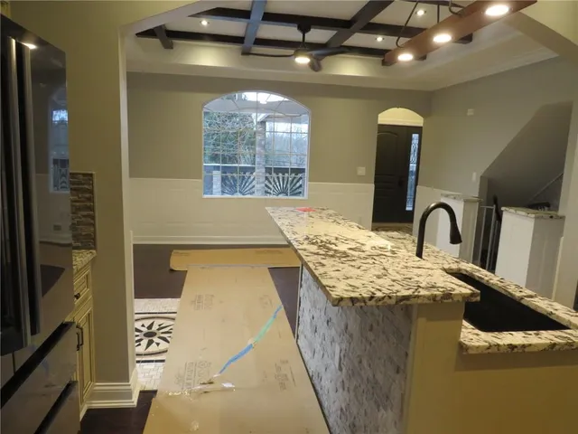 a bathroom with a granite countertop white toilet
