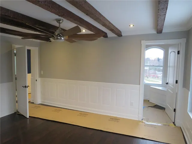 a room with wooden floor and staircase