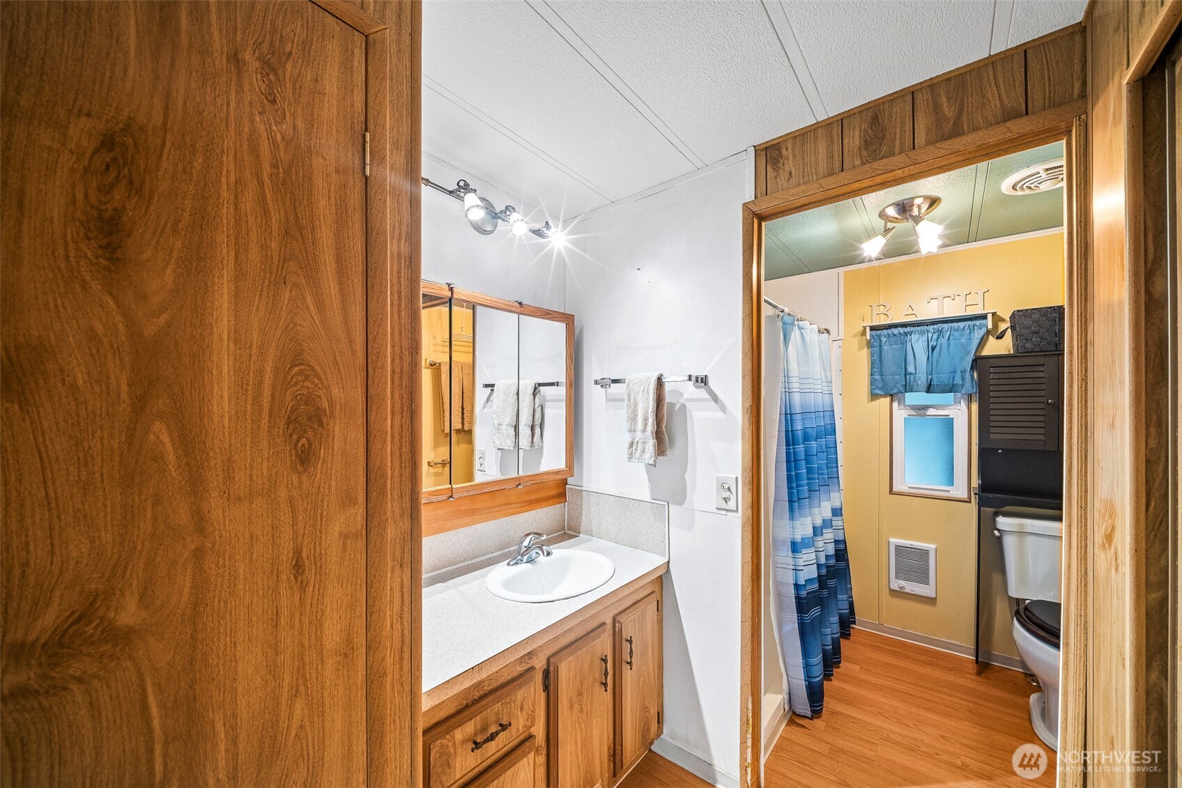 930 Trosper Road Southwest, Unit 43 Tumwater, WA 98512 - Photo 14 of 26 a bathroom with a sink a mirror and a shower