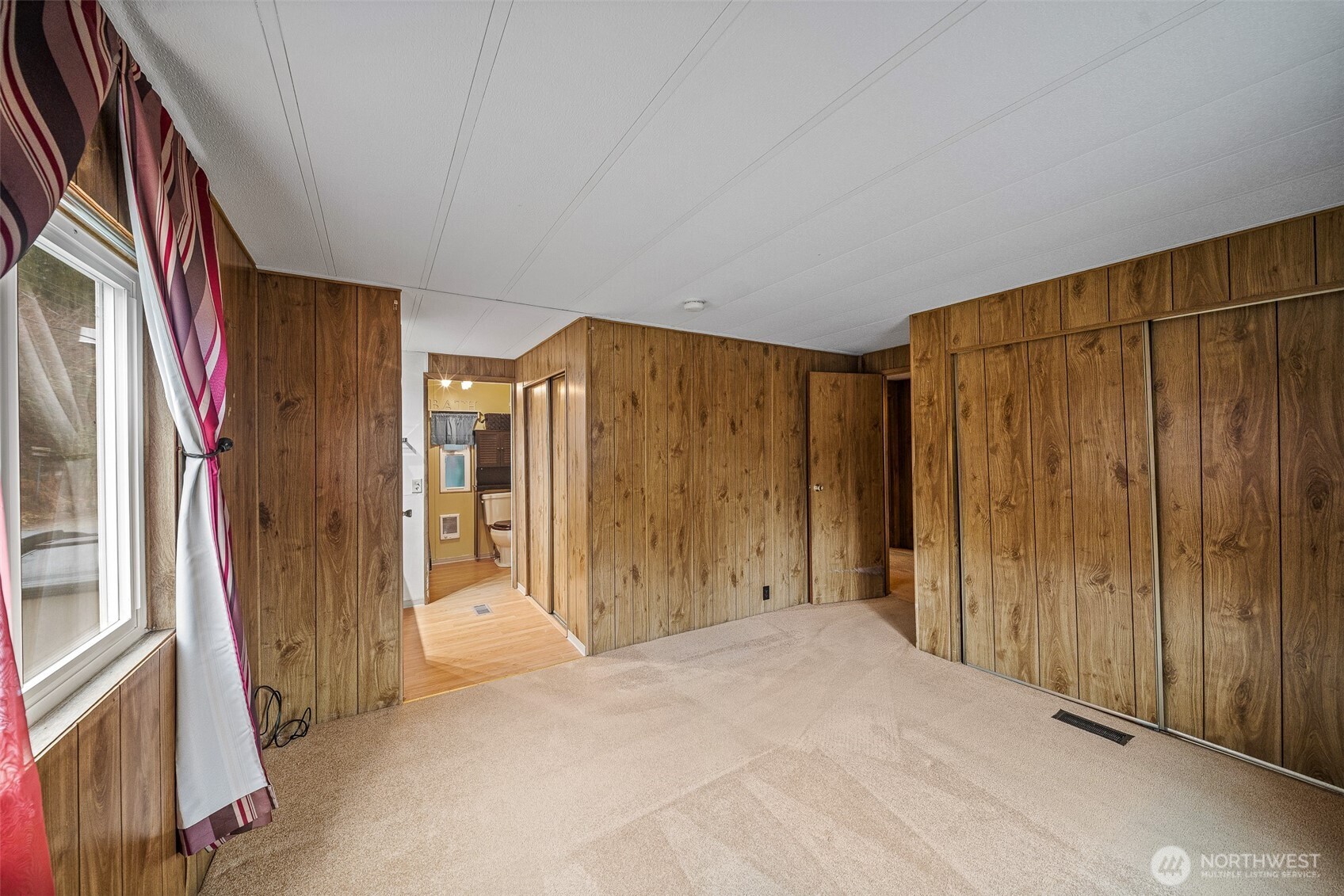 930 Trosper Road Southwest, Unit 43 Tumwater, WA 98512 - Photo 17 of 26 a view of a hallway with wooden walls and windows
