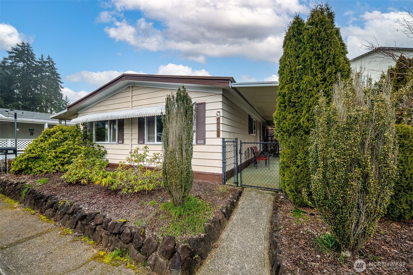 930 Trosper Road Southwest, Unit 43 Tumwater, WA 98512 - Photo 2 of 26 a front view of a house with a yard and pathway