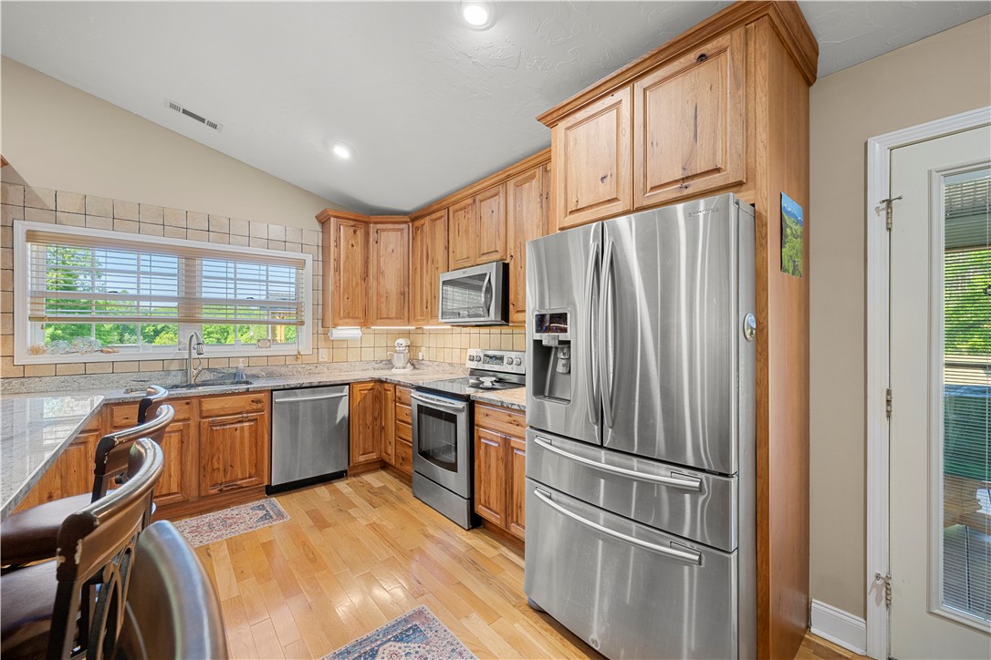 304 West A 144 Walhalla, SC 29691 - Photo 18 of 43 This bright kitchen features wood cabinetry, stainless steel appliances, and gleaming hardwood floors.