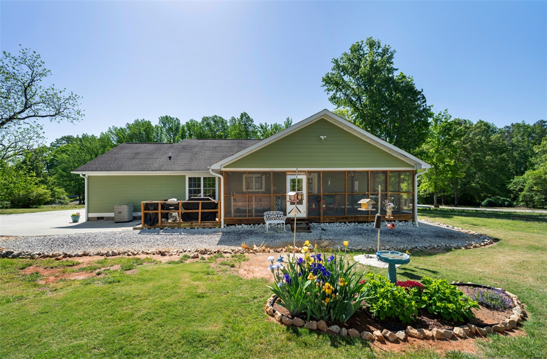 304 West A 144 Walhalla, SC 29691 - Photo 36 of 43 This charming home offers a serene outdoor oasis with lush landscaping and a spacious screened porch.