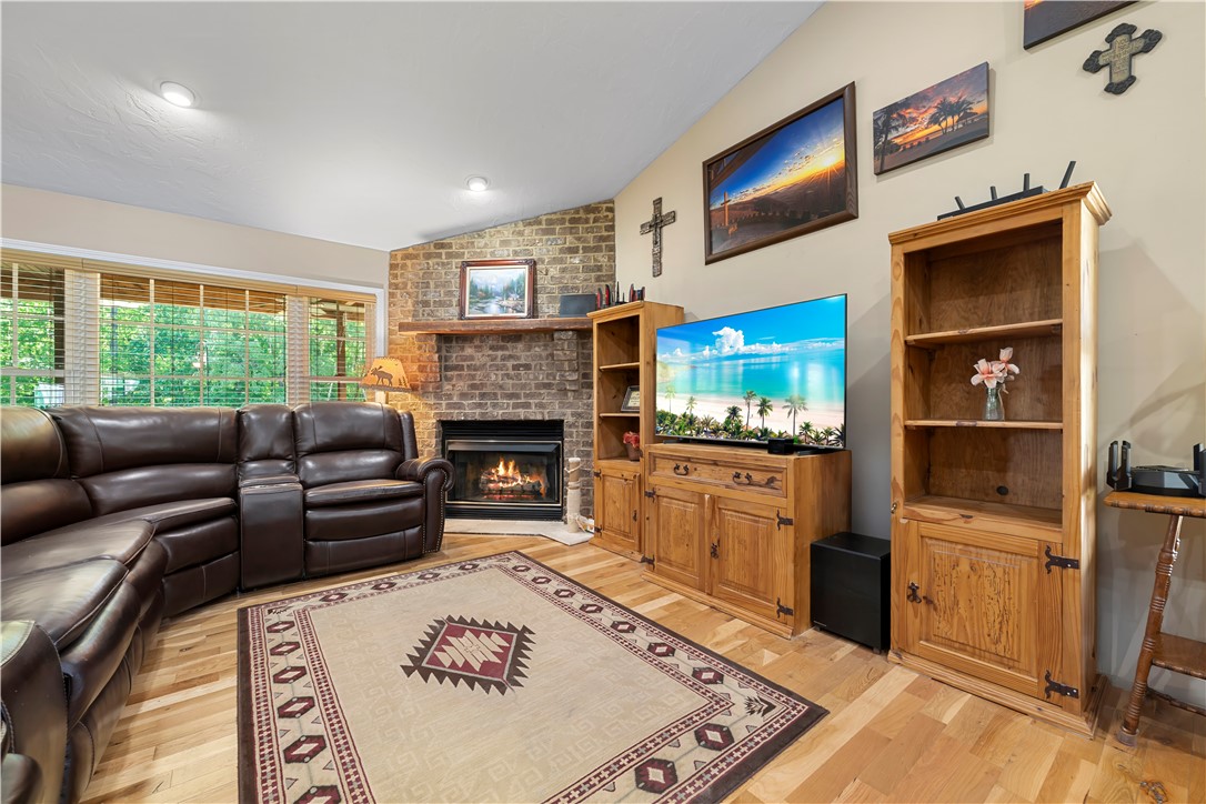 304 West A 144 Walhalla, SC 29691 - Photo 6 of 43 This inviting living space features warm wood flooring and a cozy fireplace, perfect for relaxation.
