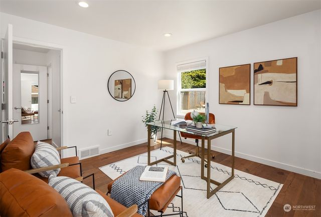 a kitchen with stainless steel appliances kitchen island granite countertop a dining table and chairs