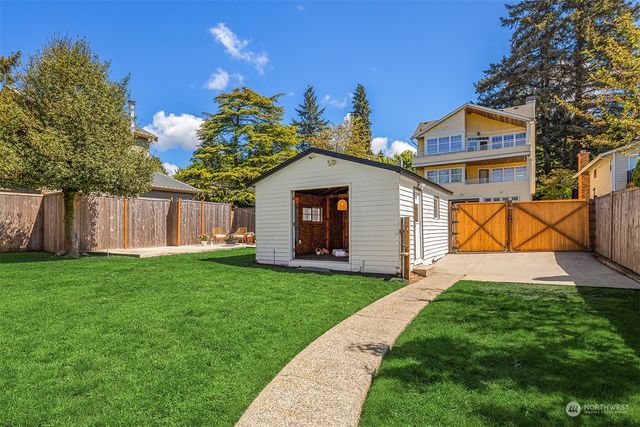 a view of a chairs and table in a backyard