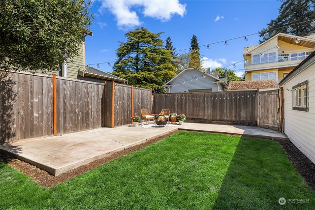 a house is sitting in middle od the grass