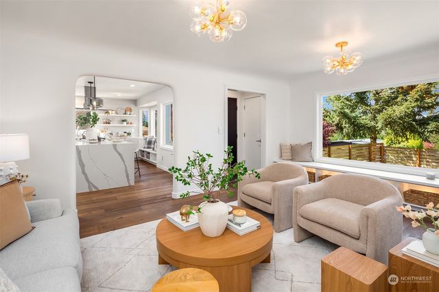 a living room with furniture a table and a chandelier