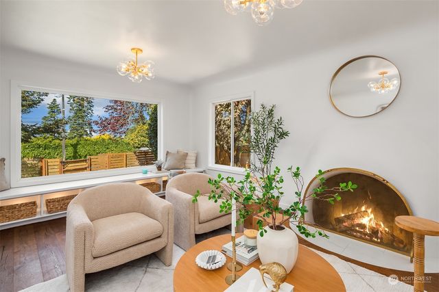 a kitchen with stainless steel appliances kitchen island granite countertop a stove a sink and a dining table with white cabinets