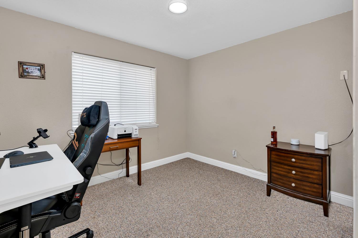 1406 San Rafael Street Los Banos, CA 93635 - Photo 18 of 35 a room with furniture and wooden floor