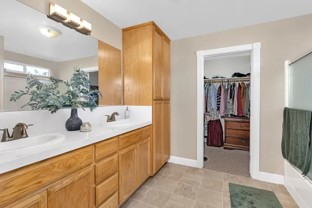 a bathroom with a double vanity sink a and mirror