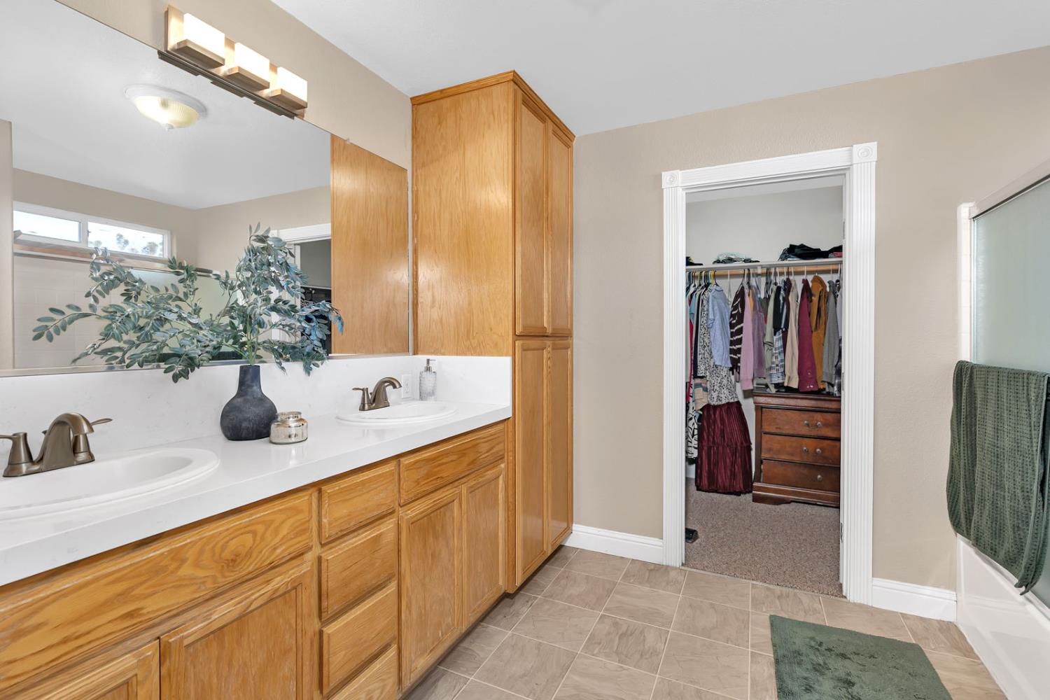 1406 San Rafael Street Los Banos, CA 93635 - Photo 24 of 35 a bathroom with a double vanity sink a and mirror