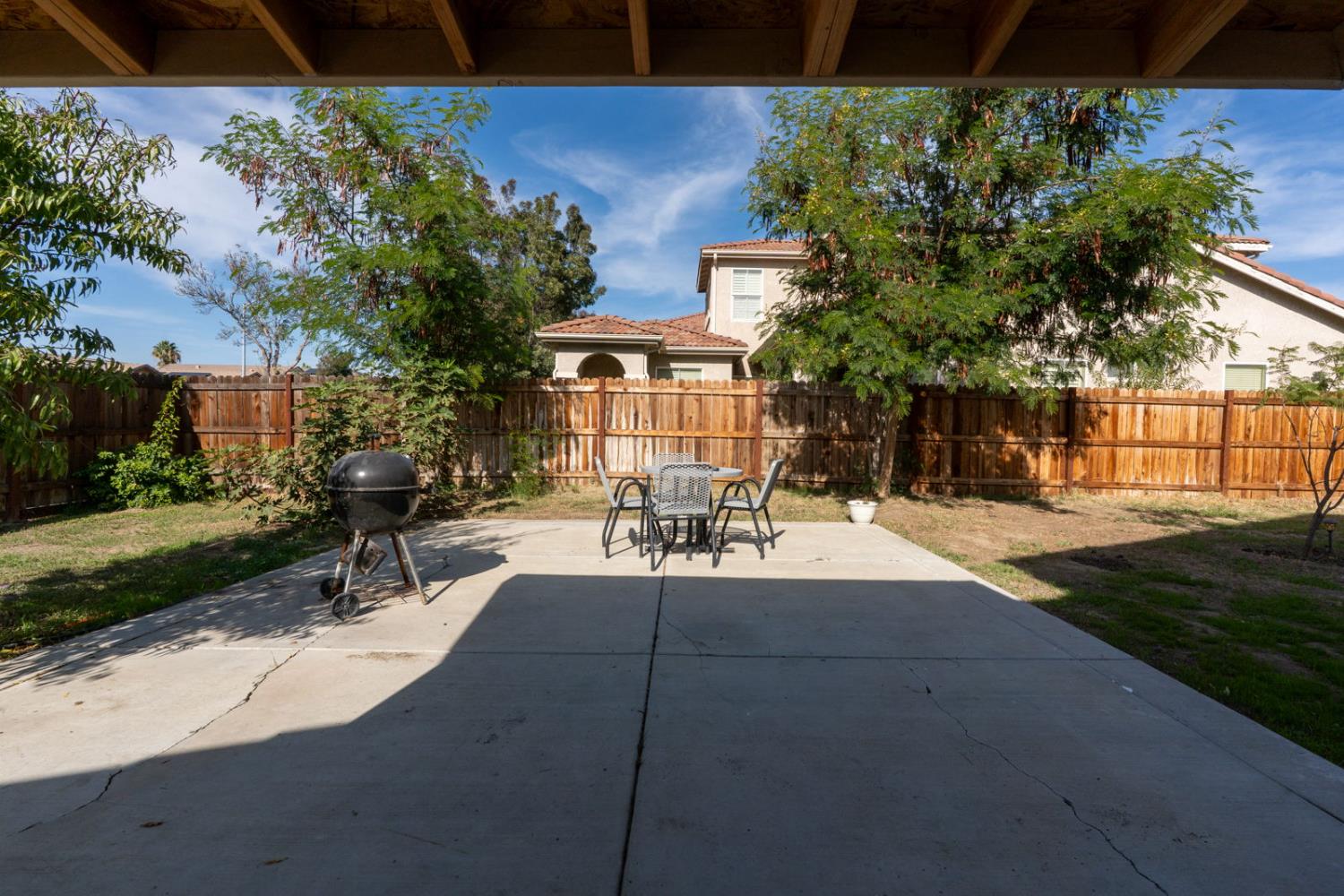 1406 San Rafael Street Los Banos, CA 93635 - Photo 32 of 35 a view of a patio with table and chairs and potted plants