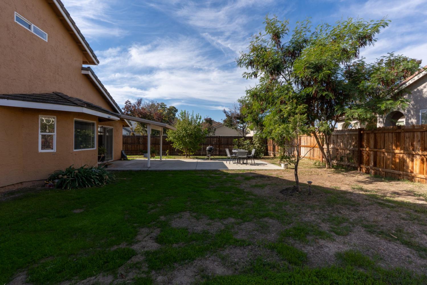 1406 San Rafael Street Los Banos, CA 93635 - Photo 35 of 35 a view of a house with backyard and a tree