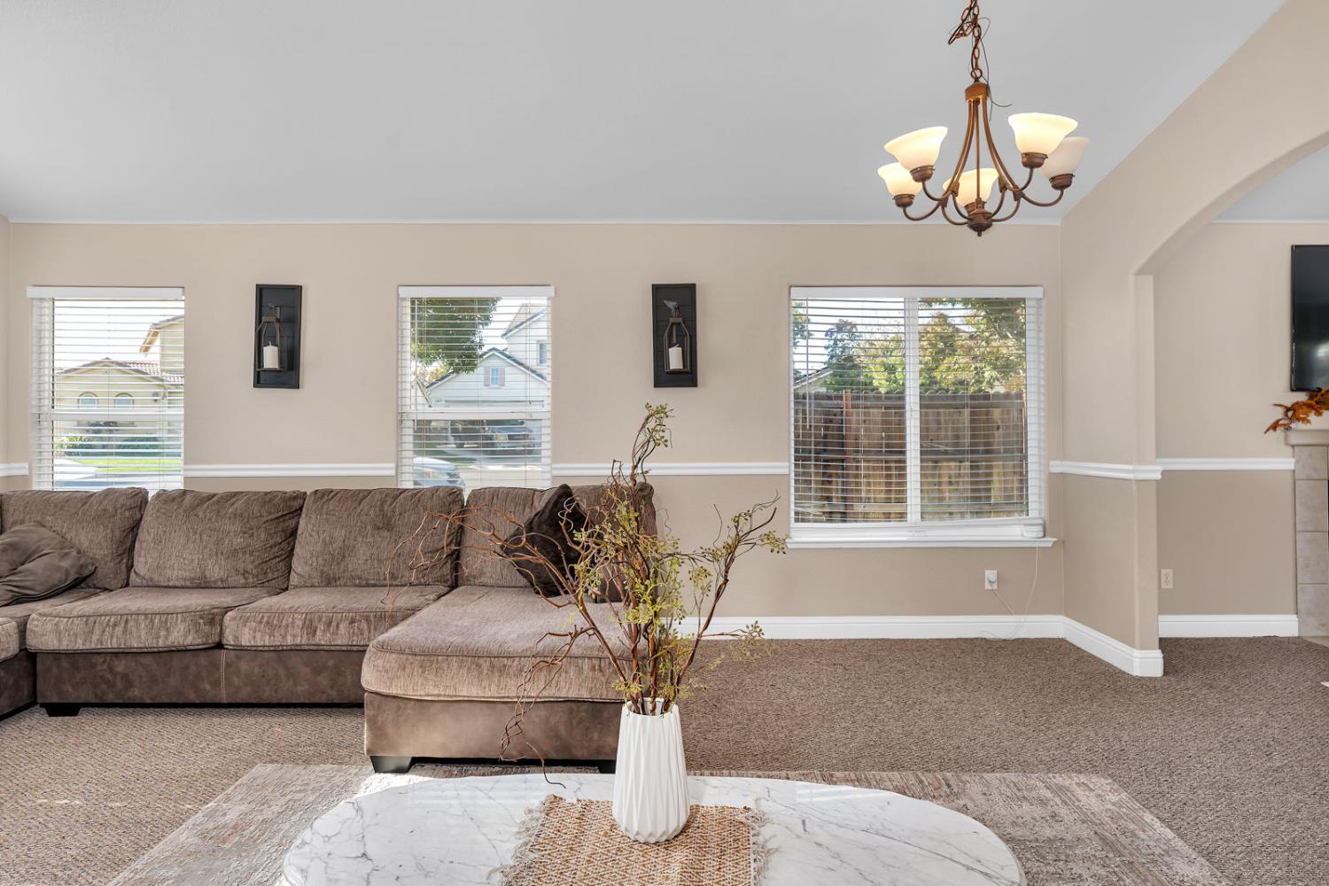 1406 San Rafael Street Los Banos, CA 93635 - Photo 5 of 35 a living room with furniture and a chandelier