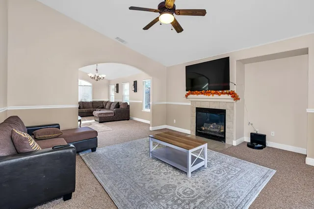 a living room with furniture and a fireplace