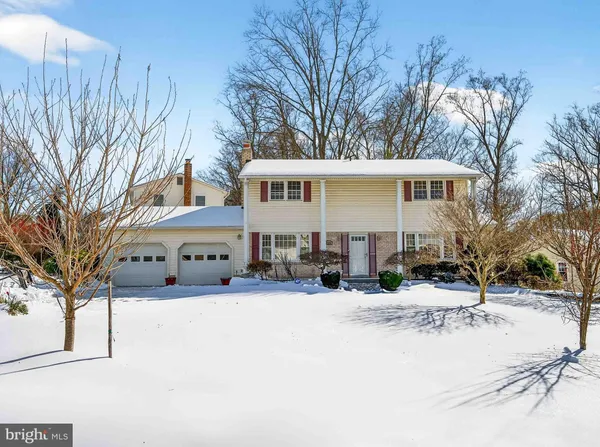 a view of a house with snow on the road