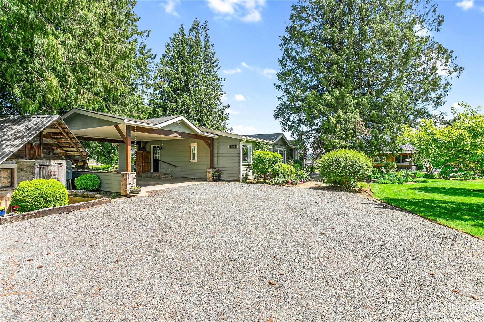 8338 Bob Hall Road Lynden, WA 98264 - Photo 30 of 37 a front view of a house with a garden and trees