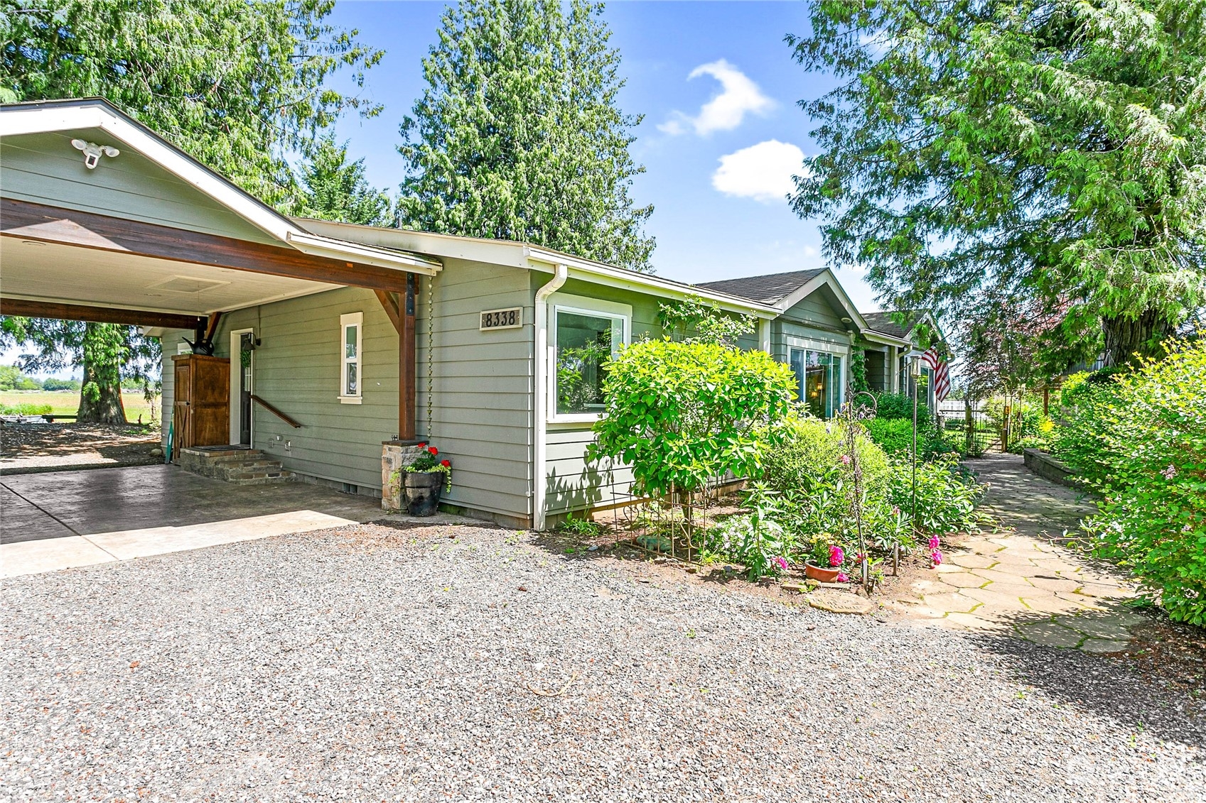 8338 Bob Hall Road Lynden, WA 98264 - Photo 35 of 37 a front view of a house with a yard and potted plants