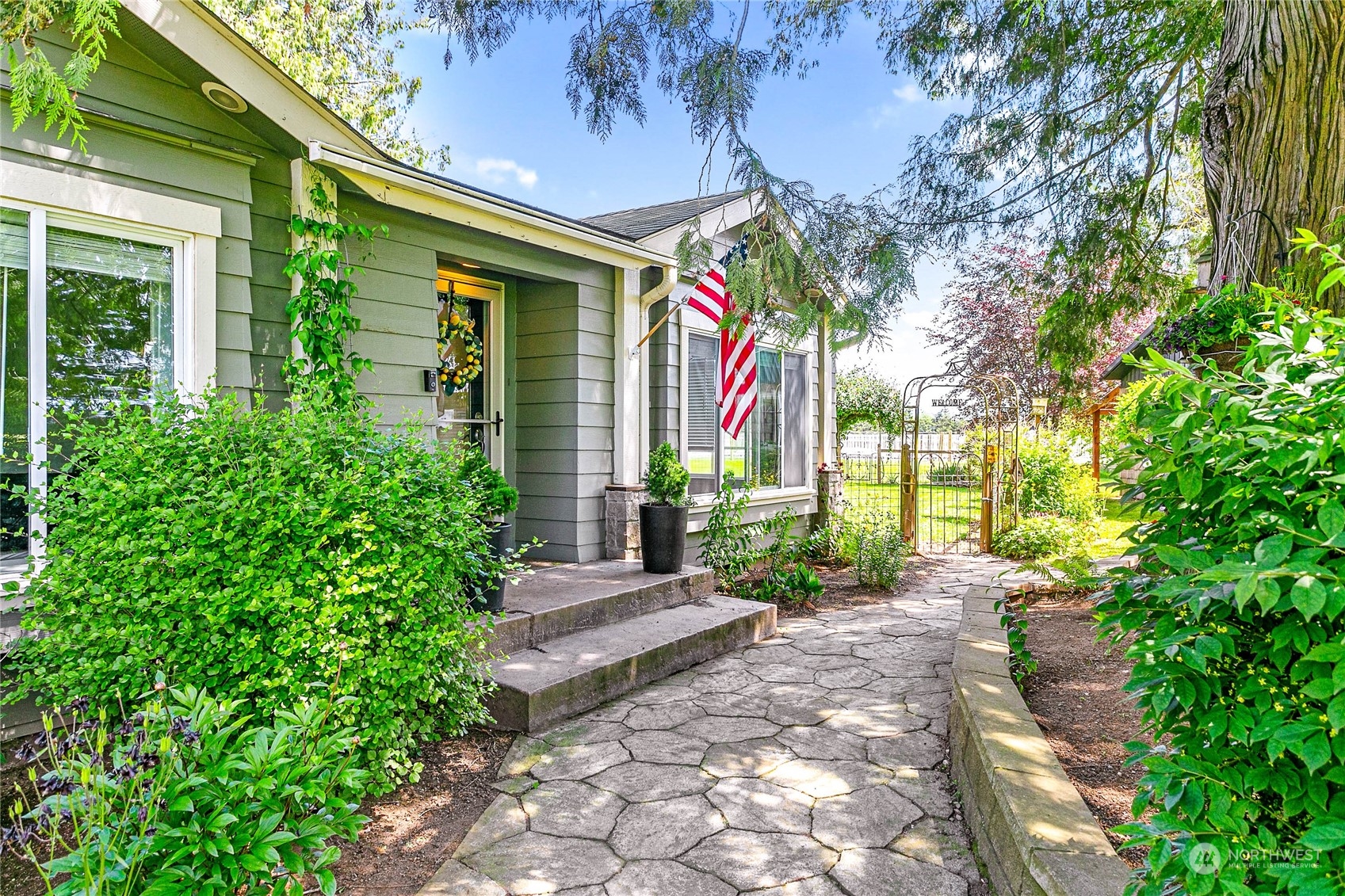 8338 Bob Hall Road Lynden, WA 98264 - Photo 36 of 37 a front view of a house with a yard and potted plants