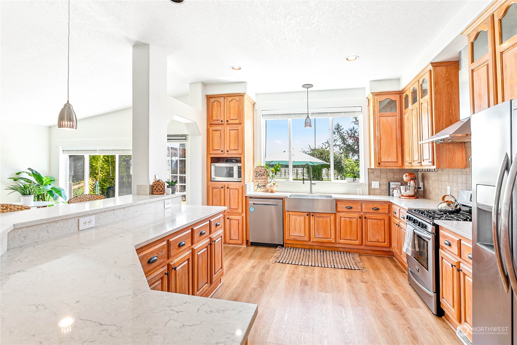 8338 Bob Hall Road Lynden, WA 98264 - Photo 7 of 37 a large kitchen with stainless steel appliances a large window a sink and counter space