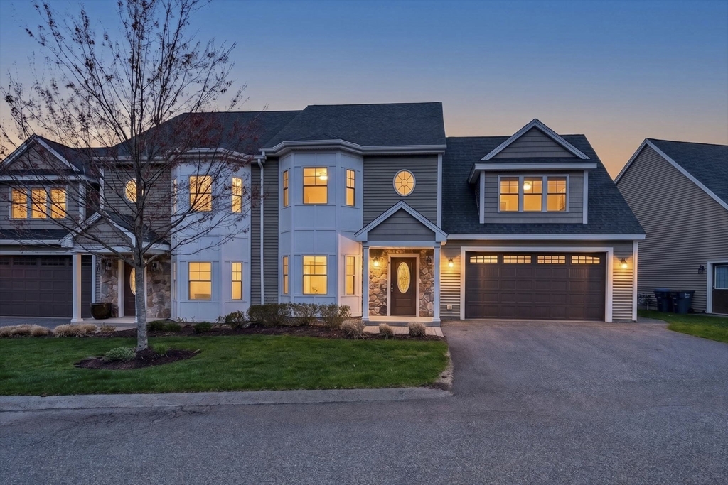 129 Acton Street, Unit 16 Maynard, MA 01754 - Photo 1 of 41 a front view of a house with a yard and garage