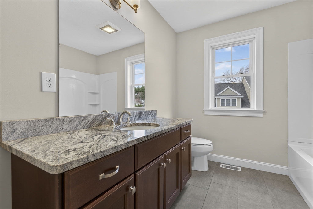 129 Acton Street, Unit 16 Maynard, MA 01754 - Photo 17 of 41 a bathroom with a granite countertop sink and a mirror