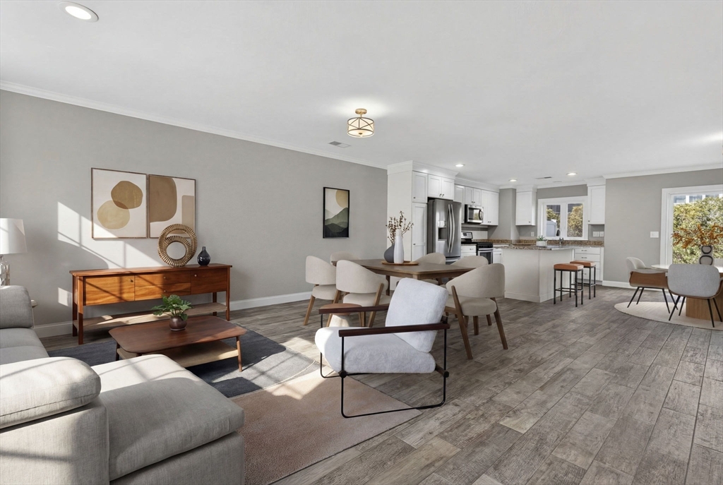 129 Acton Street, Unit 16 Maynard, MA 01754 - Photo 3 of 41 a living room with furniture and a dining table with wooden floor