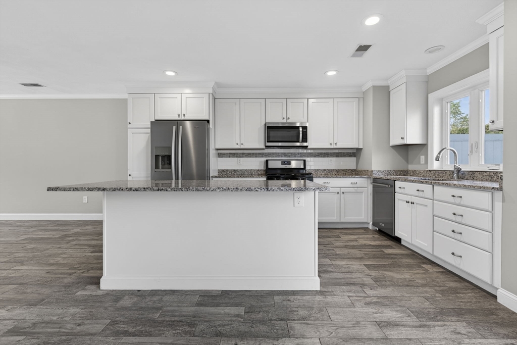 129 Acton Street, Unit 16 Maynard, MA 01754 - Photo 6 of 41 a large kitchen with cabinets
