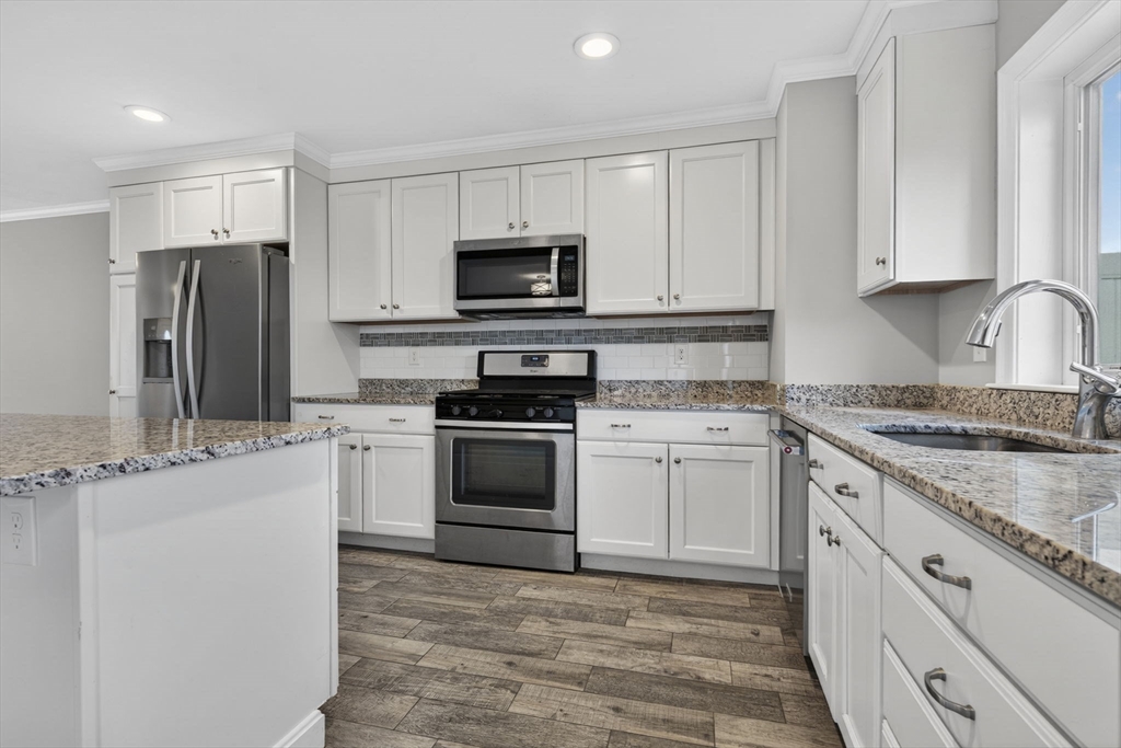 129 Acton Street, Unit 16 Maynard, MA 01754 - Photo 10 of 41 a kitchen with white cabinets stainless steel appliances and sink