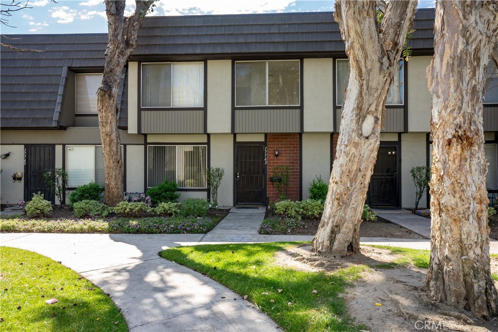 a house that has a tree in front of it