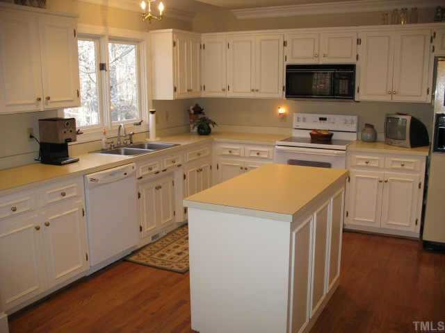 1405 Bascomb Drive Raleigh, NC 27614 - Photo 5 of 12 Kitchen with painted cabinets, island, smooth surface range, MW, desk, pantry and hardwood floors. Other