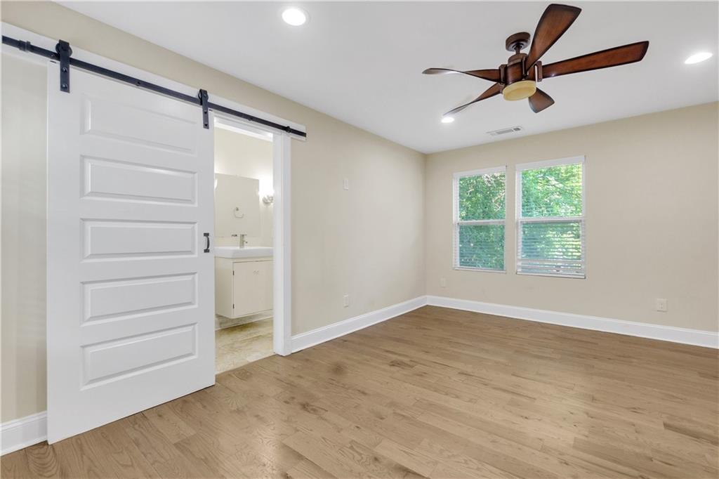 998 Mayson Turner Road Northwest, Unit A Atlanta, GA 30314 - Photo 14 of 26 a view of room with a ceiling fan and hardwood floor