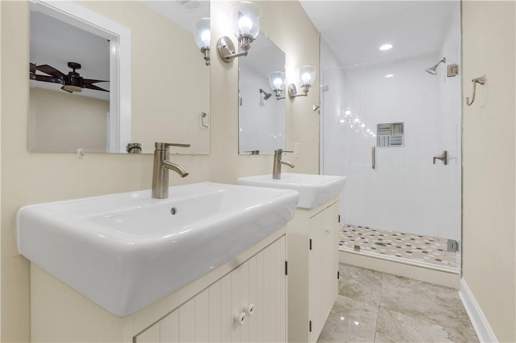 998 Mayson Turner Road Northwest, Unit A Atlanta, GA 30314 - Photo 17 of 26 a bathroom with a sink a toilet a mirror and shower