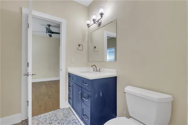 a bathroom with a toilet a sink and mirror